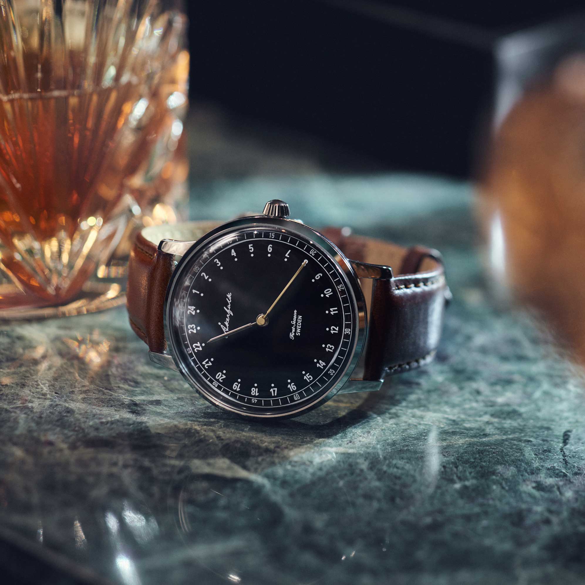 24-hour watch with silver case and brown leather strap