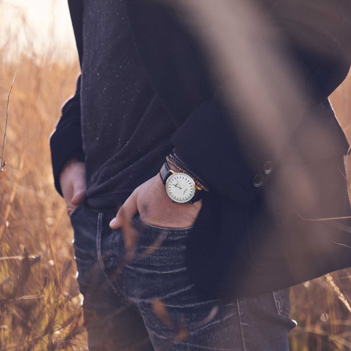 24-hour watch with gold case and black leather strap